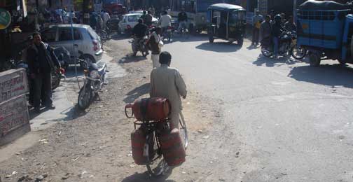 Bicycle with three gas canisters tied onto it.