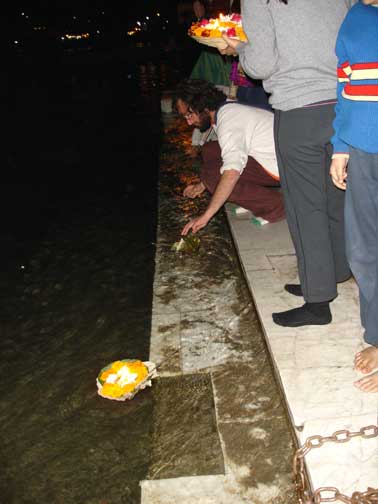 Flower arrangements are set adrift in the Ganges River.