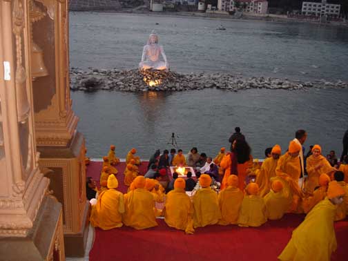 Evening prayer service at Rishikesh with statue of Shiva.