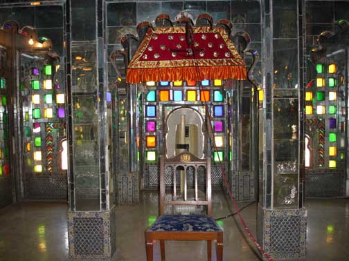 Ornate room with manual fan in City Palace in Udaipur.